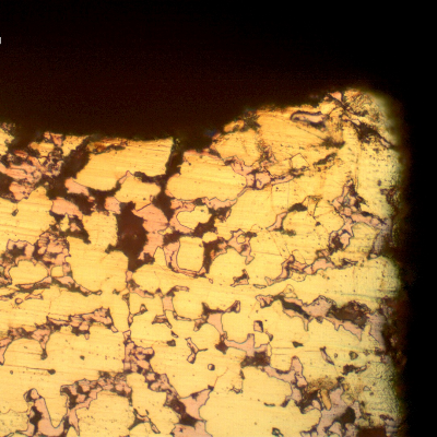 Micrographic detail of the dezincification effect, where the beta phase is preferentially corroded, leaving a cooper rich phase (red) that is porous and easily cracks.