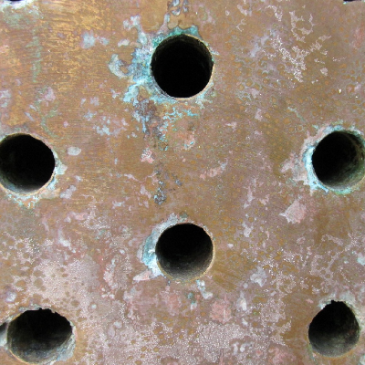 Aspect of the tubesheet after removal of the cooper alloy tubes and water cleaning. The corrosion is more intense in the regions of tube connection.
