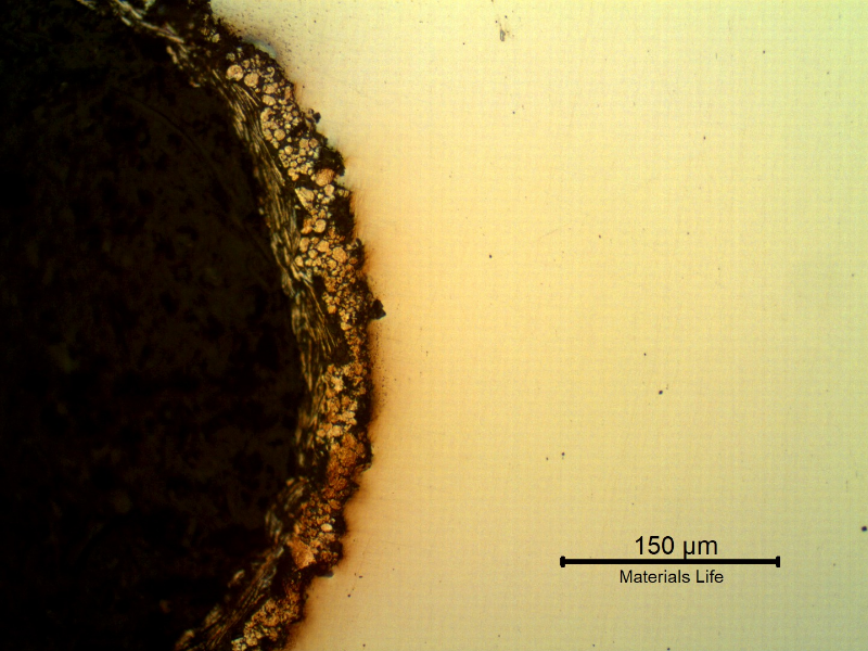 Micrography of the longitudinal section of the bolt at the bottom of the thread fillet, in the "as polished" condition, showing the zinc flakes coating layer, applied by a painting process that do not create metallurgical bonding with the substrate.