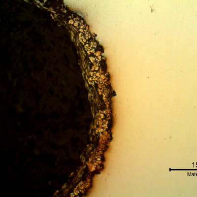 Micrography of the longitudinal section of the bolt at the bottom of the thread fillet, in the "as polished" condition, showing the zinc flakes coating layer, applied by a painting process that do not create metallurgical bonding with the substrate.