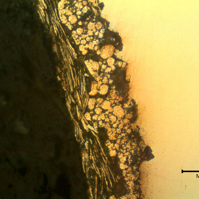 Micrographic detail of the zinc flakes coating layer in the "as polished" condition of a longitudinal section of the bolt.
