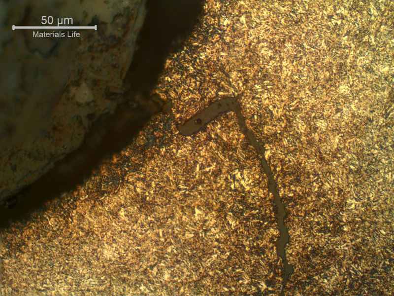 Micrography of the longitudinal section of the stud showing a crack from the thread fillet, of a ductile aspect, opened during torque.