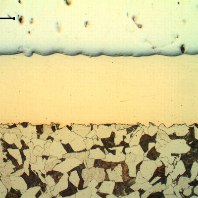 Micrography of the longitudinal section of the cylinder , at the surface, where it was not yet damaged. The steel substrate is in the bottom of the figure, the Ni layer is in the center and the Cr layer is in the top of the figure.
