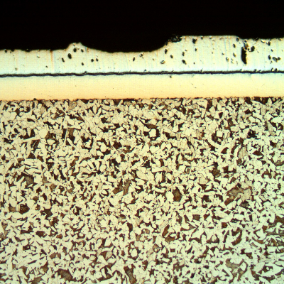 Micrographic aspect, after Nital etching, of the longitudinal section of the cylinder, at the surface, in a region where the damage is in the begining.  There are two layers at the surface.  A first Ni layer, 160 microns thick and 300HV average hardness, over the low carbon steel substrate, 200HV average hardness, and a chromium plated layer, 250 microns thick and 1100HV average hardness.