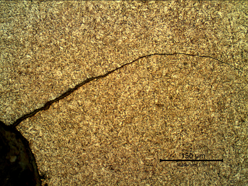 Micrography of a longitudinal section, at the fillet that was tightened (to the end of the bolt) adjacent to the fracture. The cracking is typical of localized overloading, probably because it was only partially tightened in the tapped hole.