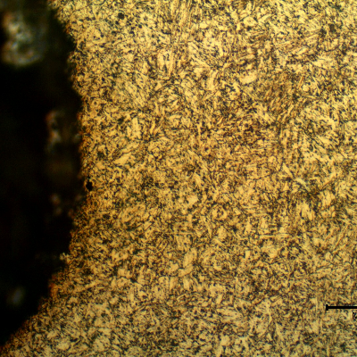 Micrographic detail of the rolled thread that was heat treated later. The bolt was quenched and tempered to 30 HRc and presented a martensitic structure.