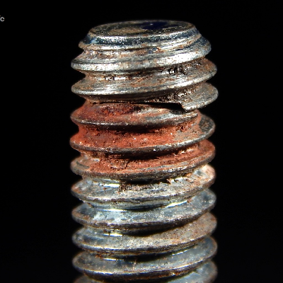 The corrosion marks in the thread surface indicate that the bolt was not properly tightened in the tapped hole.  The length of thread engagement should be at least  1x of the bolt diameter, in this case 3/8".