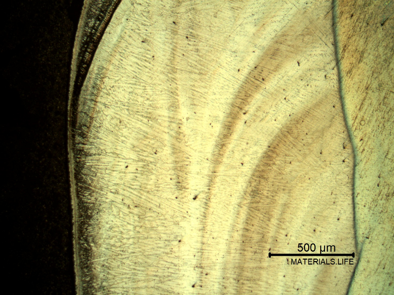 Low magnification micrography of a longitudinal section of the pipe at the interface,with oxalic acid electrolytic method that overetchs the low alloy steel structure (to the left side of the image), and reveals the structure of the clad interface.