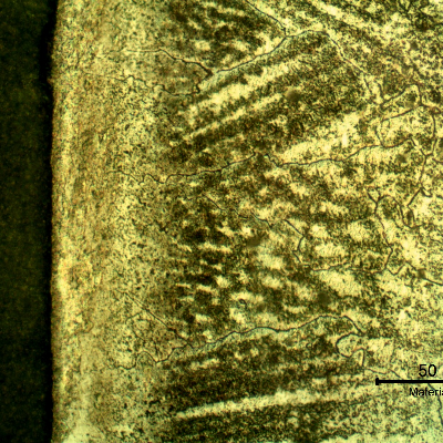 Micrographic detail of a longitudinal section of the pipe at the interface,with oxalic acid electrolytic revealing the structure of the clad interface. Celular structure and transgranular precipitation.