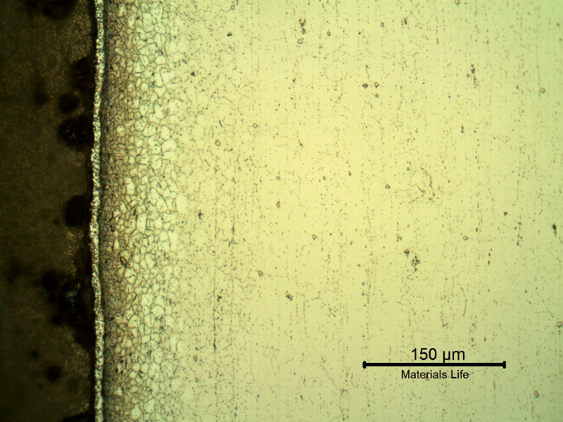 Micrography of the metallurgically bonded interface of the internally cladded pipe. The region is a detail in the side of the Ni alloy clad plate where a grain refinement has occurred probably due to recrystallization of a strain hardened region during later heat treatment.