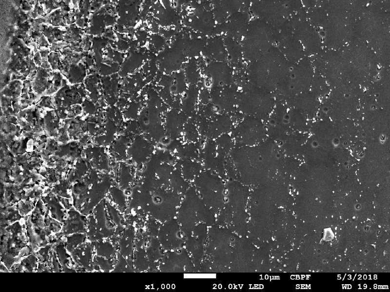 Image by scanning electron microscopy of the metallurgically bonded interface of the internally cladded pipe.  It is a longitudinal seam welded pipe, with substrate in low alloy steel X65 and clad plate in Alloy 625 (welded by a solid state process). The region is a detail in the side of the Ni alloy clad plate where a grain refinement has occurred probably due to recrystallization of a strain hardened region during later heat treatment. The microhardness of this region is a lot higher than the value obtained out of this region, in the clad plate.