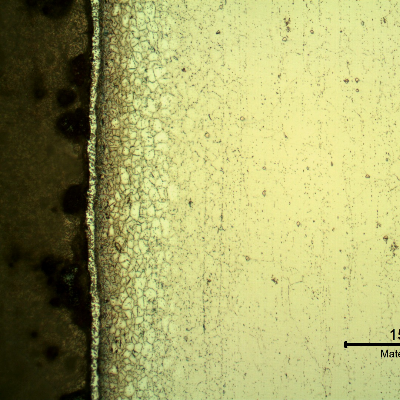 Micrography of the metallurgically bonded interface of the internally cladded pipe. The region is a detail in the side of the Ni alloy clad plate where a grain refinement has occurred probably due to recrystallization of a strain hardened region during later heat treatment.
