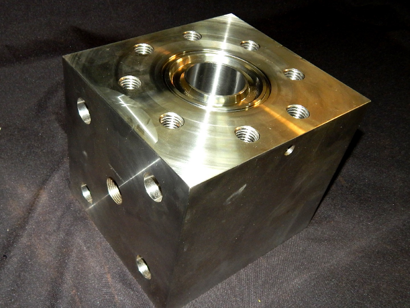 Aspect of the cracked valve body, after disassembling and removing the internal parts.  The valve is part of a lot that was manufactured by forging a cubic 170mm from a  forged bar in SDSS UNS S32760, and heat treated (solution annealed) by the forging company. The fabrication using these bodies included the machining, fillet weld two inserts in Alloy 625, machining again, assembling the internals, and pressure test at 15,000 psi.  The cracking occurred during test, only for this valve body.