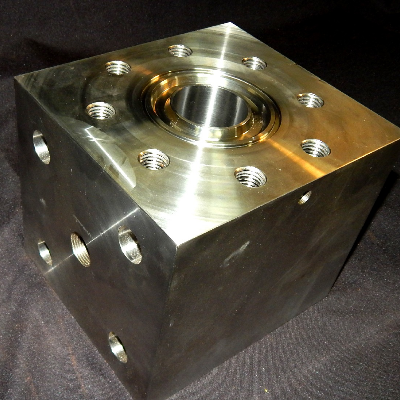 Aspect of the cracked valve body, after disassembling and removing the internal parts.  The valve is part of a lot that was manufactured by forging a cubic 170mm from a  forged bar in SDSS UNS S32760, and heat treated (solution annealed) by the forging company. The fabrication using these bodies included the machining, fillet weld two inserts in Alloy 625, machining again, assembling the internals, and pressure test at 15,000 psi.  The cracking occurred during test, only for this valve body.