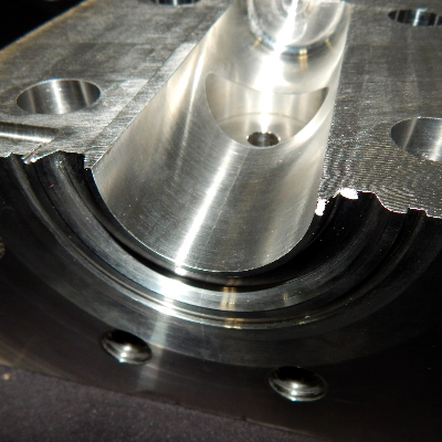 Aspect of a section cut transverse to the center of the body.  The crack is brittle, trough wall, and was arrested in the region where the valve body was welded to the insert.