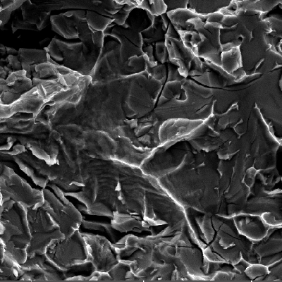 Fractographic detail of the valve body fracture surface after opening the crack.  The fracture micromechanism is brittle, by cleavage, with several secondary microcracks associated to the sigma phase.