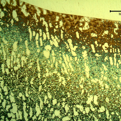 Low magnification micrography of the valve at the welded joint of the body to the insert (fillet weld). The cracking was arrested at the position of this welded joint because the structures of the weld metal, insert and heat affected zones are tough (austenitic in the weld metal and insert, and free from sigma in the HAZ) .