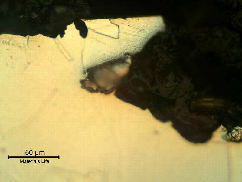 Micrographic detail of the damaged region close to the external surface, presenting a shallow localized dissolution/corrosion.