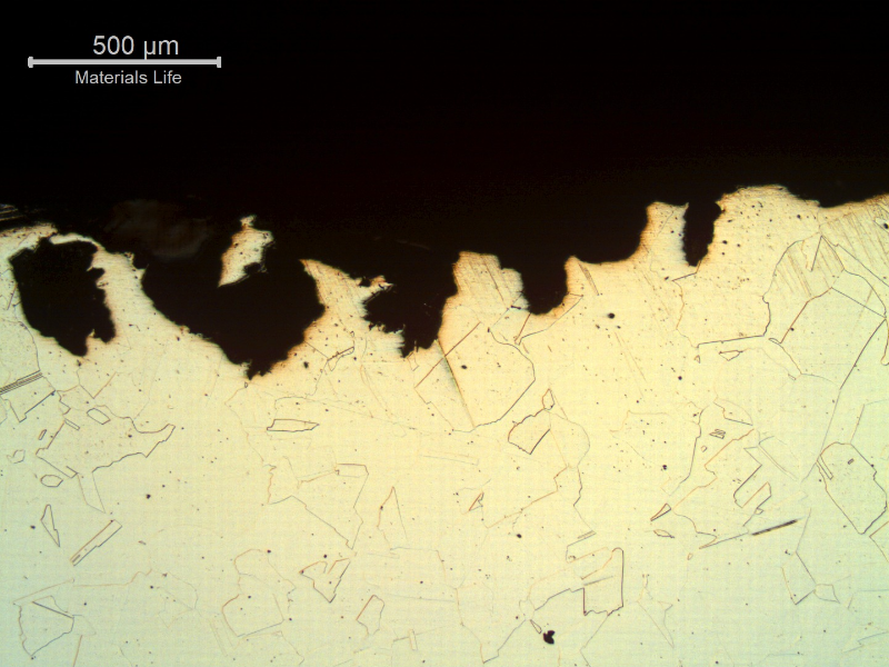 Micrography of the damaged region close to the internal surface, presenting spots of localized dissolution/corrosion.