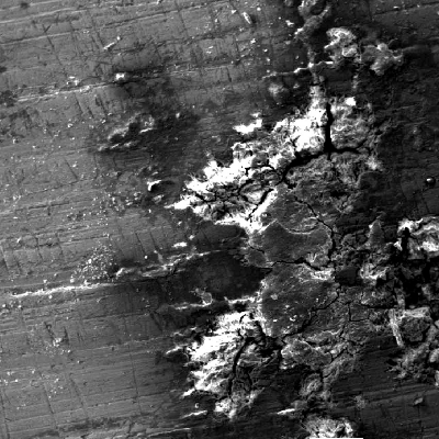 Microscopical aspect by scanning electron microscopy (SEM) of the external surface of a drilling tool in a position that presented localized deposits and corrosion under deposit. The deep corrosion in a short time is only possible associated to the biological growth and aggressive environment generated by the microorganisms metabolites - Microbiologically Induced Corrosion (MIC).