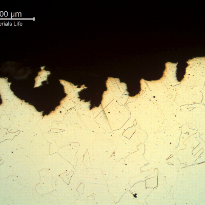 Micrography of the damaged region close to the internal surface, presenting spots of localized dissolution/corrosion.
