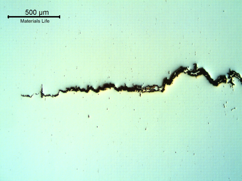 As polished micrography of the longitudinal section of the stud at the cracking transverse to the axis. It looks like inclusions/possible banding regions are contributing for the cracking.