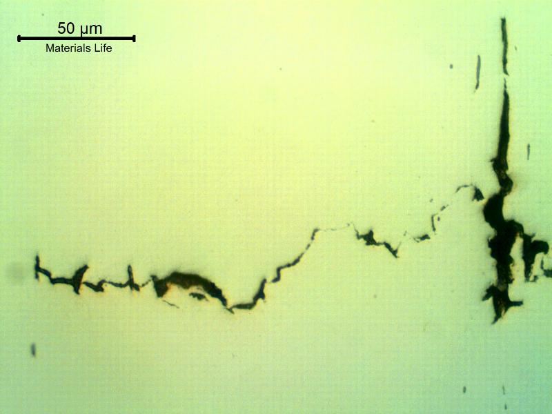 As polished micrography of the longitudinal section of the stud at the cracking transverse to the axis. It looks like inclusions/possible banding regions are contributing for the cracking.