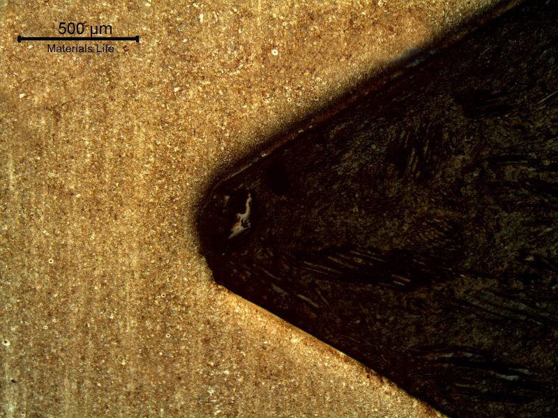 Longitudinal section micrography in a position of the thread, far from the failure. The stud presented a quenching and tempering structure and the thread was machined.