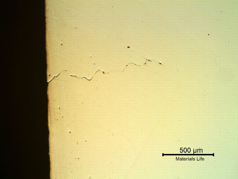 Micrography of a longitudinal section of the spring indicating that under the deposits there are intergranular cracks initiating at the spring surface.