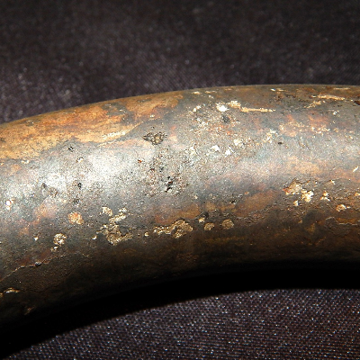 Corroded spots (shallow pits) at the spring surface.