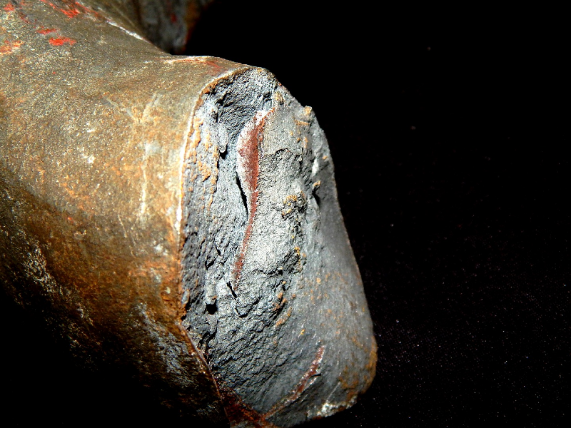 Aspect of the other side of the fracture of the 2" diameter lifting device. It failed in a brittle way during loading test.  The zinc coating was partially removed from the casting surface of one side of the failed part, for inspection, looking for casting defects. The results showed that the casting part did not present casting defects.