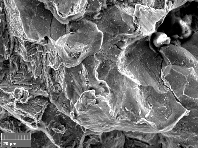 Scanning electron fractography (originally 2000x), showing intergranular aspects in the fracture surface.