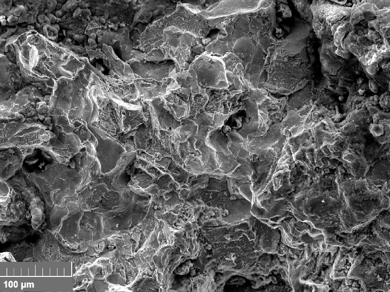 Scanning electron fractography (originally 500x), showing intergranular aspects in the fracture surface.