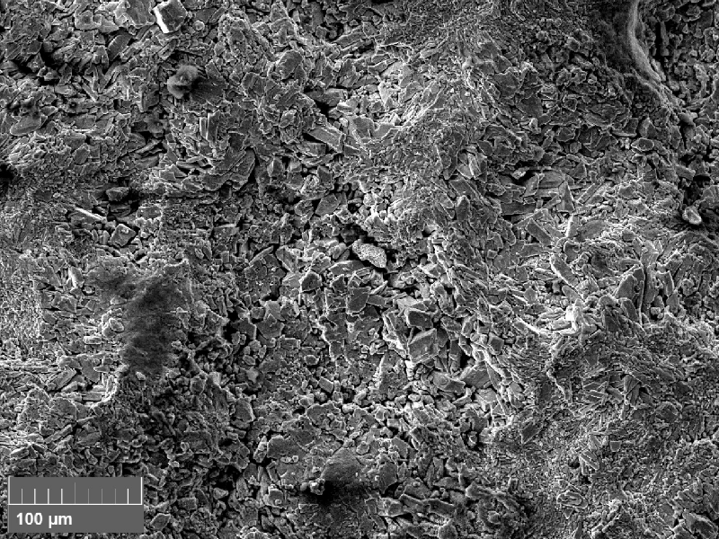 Scanning electron fractography (originally 500x), showing zinc deposits at the fracture surface.