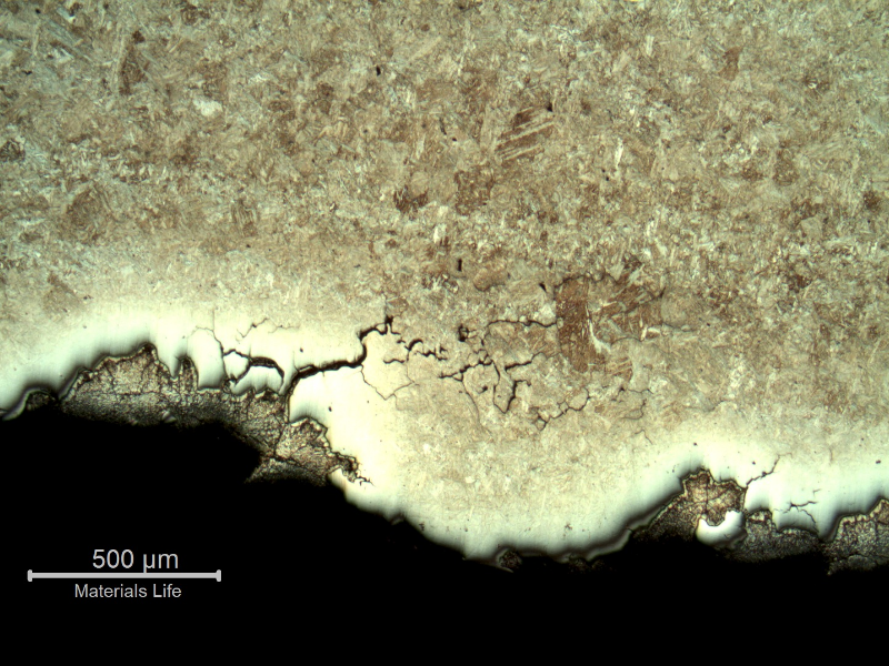 Micrography of the branch cracking parallel to the fracture. There are several secondary intergranular cracks and the cracks are filled with zinc. The zinc appears dark because of the Nital etch, and the steel close to the cracking is not fully revealed because of the protection by the zinc.
