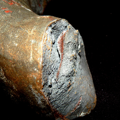Aspect of the other side of the fracture of the 2" diameter lifting device. It failed in a brittle way during loading test.  The zinc coating was partially removed from the casting surface of one side of the failed part, for inspection, looking for casting defects. The results showed that the casting part did not present casting defects.