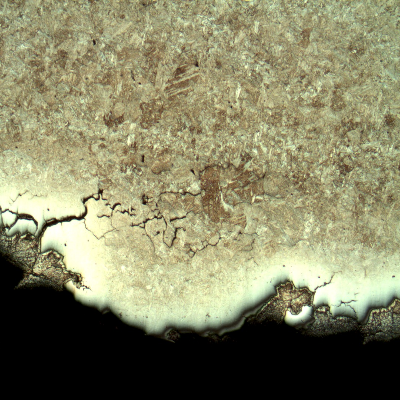 Micrography of the branch cracking parallel to the fracture. There are several secondary intergranular cracks and the cracks are filled with zinc. The zinc appears dark because of the Nital etch, and the steel close to the cracking is not fully revealed because of the protection by the zinc.