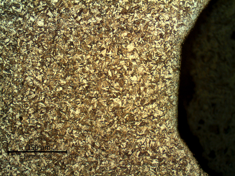 Micrography of a longitudinal section of the 5/8" bolt, at the bottom of the thread, presenting a refined structure compared to the center of the bolt.  The structure is  aged martensite.