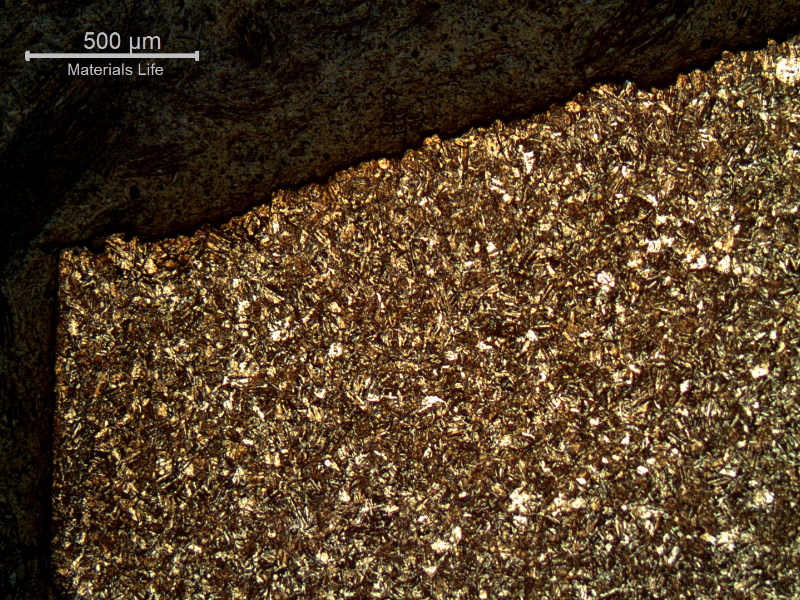Micrography of a longitudinal section of the bolt, close to the fracture surface (top of the figure).  The fracture is macroscopically flat and started at the surface (left side) in a position close to the bolt body to bolt head transition. The structure is aged martensite.