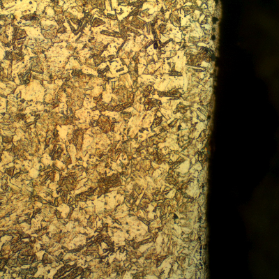 Micrographic detail of the aged martensite structure, refined when compared to the structure in the center of the bolt.