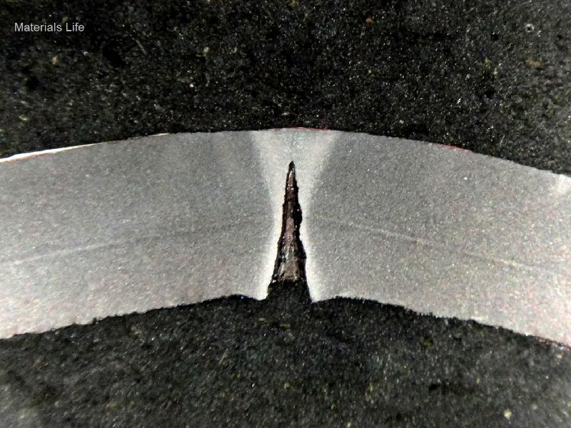 Macrography of a transverse section of the pipe, 8 mm thick, presenting localized dissolution at the longitudinal autogenous seam weld.