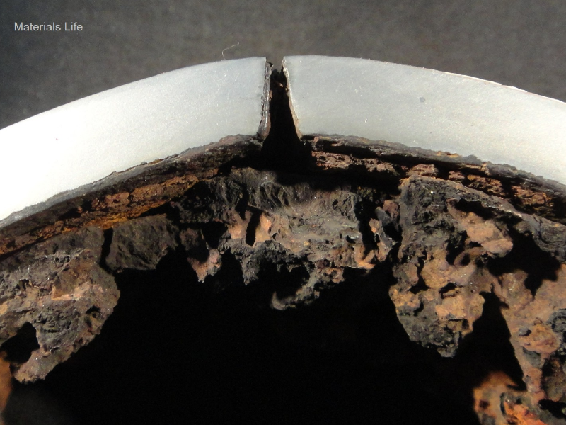 Detail of the transverse section of the 4" pipe at the longitudinal seam weld evidencing the leakage position.  The damage appears as a through wall opening.  The pipe thickness is 8 mm and there are no evidences of general corrosion (the SCH 80 corresponds to 8.6 mm) or pitting at the internal surface.