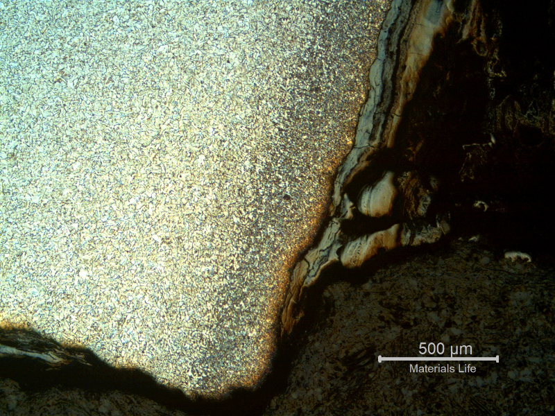 Micrography of the pipe in the leakage area, at the internal pipe surface, showing the preferential corrosion in the center of the autogenous weld and oxides inside the crevice.  The morphology of the corrosion is similar to a cracking but the analysis show that it is a localized anodic process.