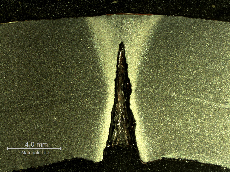 Macrography of a transverse section of the pipe presenting localized dissolution at the longitudinal autogenous seam weld.