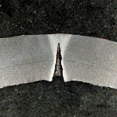 Macrography of a transverse section of the pipe, 8 mm thick, presenting localized dissolution at the longitudinal autogenous seam weld.