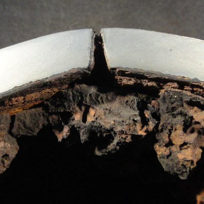 Detail of the transverse section of the 4" pipe at the longitudinal seam weld evidencing the leakage position.  The damage appears as a through wall opening.  The pipe thickness is 8 mm and there are no evidences of general corrosion (the SCH 80 corresponds to 8.6 mm) or pitting at the internal surface.