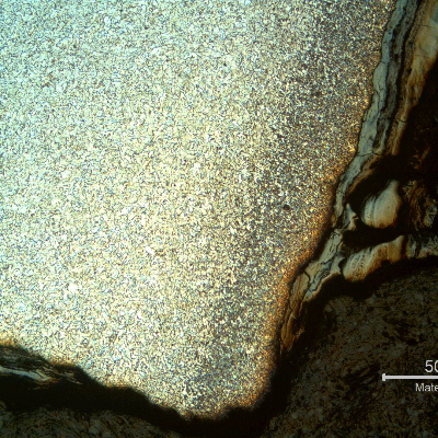 Micrography of the pipe in the leakage area, at the internal pipe surface, showing the preferential corrosion in the center of the autogenous weld and oxides inside the crevice.  The morphology of the corrosion is similar to a cracking but the analysis show that it is a localized anodic process.