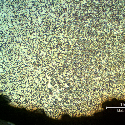 Micrography of the internal pipe surface at the leakage position showing an oxide layer inside the crevice.  The corrosion occurred exactly at the weld metal and the region at the margin of the damage shows the heat affected zone of the autogenous weld, with a refined grain size.