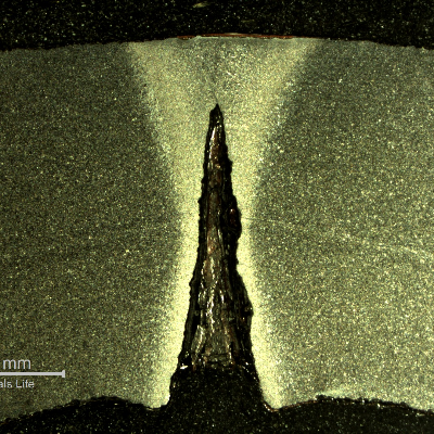 Macrography of a transverse section of the pipe presenting localized dissolution at the longitudinal autogenous seam weld.