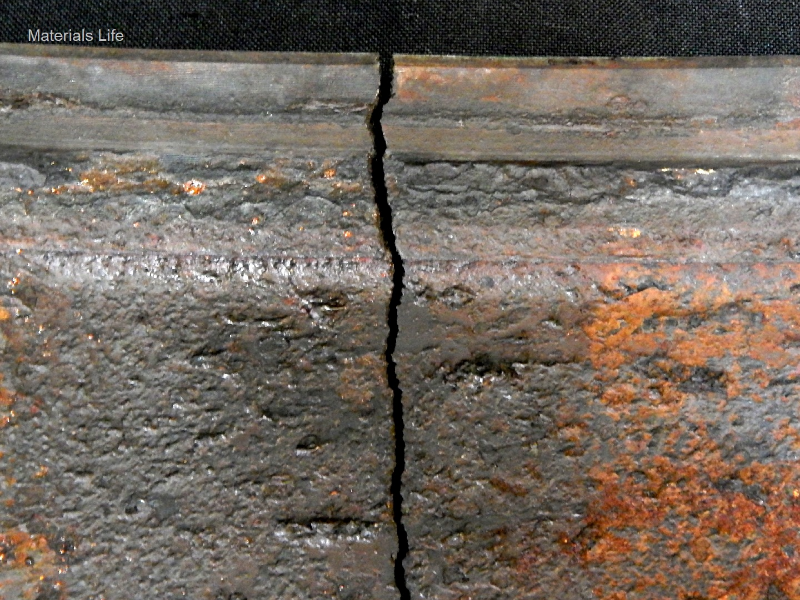 Fractured position of the casting cylinder of 10.5 mm thickness (minimum measured thickness) showing a brittle behavior (lack of plastic deformation), typical of overloading a material with 1% ductility (measured in the tensile test). This is the view of the internal surface of the cylinder, presenting regions of localized thinning in this surface that was in contact with (treated) cooling water.  The external side of the cylinder was painted.